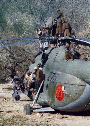 Afghan guerrillas atop a downed Afghan Mi-8T Hip-C transport helicopter. It was lost in 18.07.1979. Photo: Air International