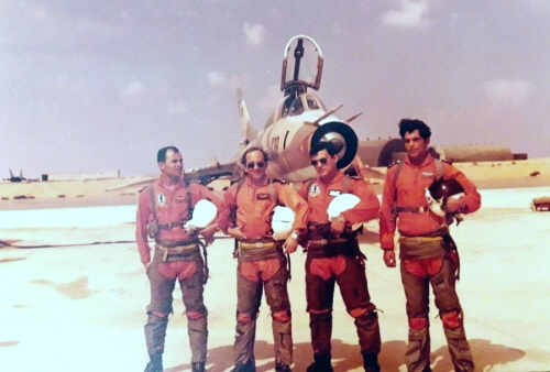Four pilots from the Libyan 1022nd Squadron in front of their Su-22M (S-52K) reconnaissance bomber. On the left in the background is the 1055th Squadron's MiG-25  Foxbat , while on the right in the background are the NATO standard hardened shelters at the Ghardabiya air base in 1986.